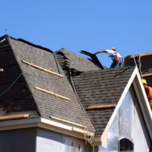 Roof contractor working on a house roof
