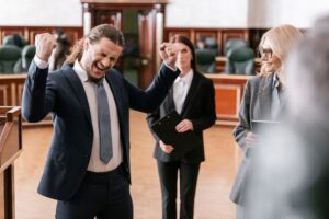 Man showing win gesture in court