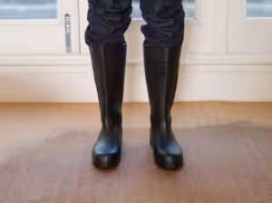 Wearing black boots and standing in floor with wet carpet Wearing black boots and standing in floor with wet carpet