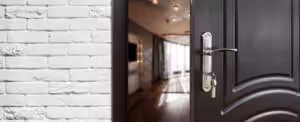 Half opened door to a house showing door handle and door lock