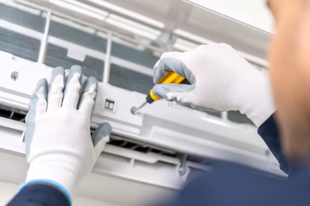 Man fixing AC unit
