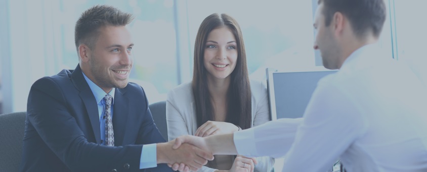 Couple shaking hands with a portfolio manager