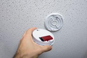 The battery of smoke detector on ceiling