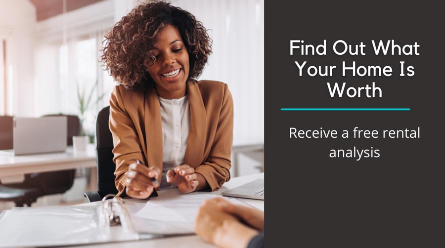 Professional woman sitting at her desk speaking with a client