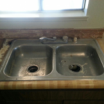 Shot of a worn, dirty kitchen sink