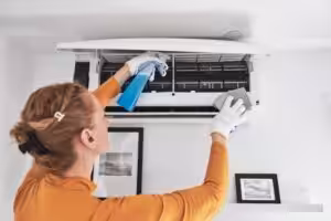 Resident cleaning airconditioner filters at home